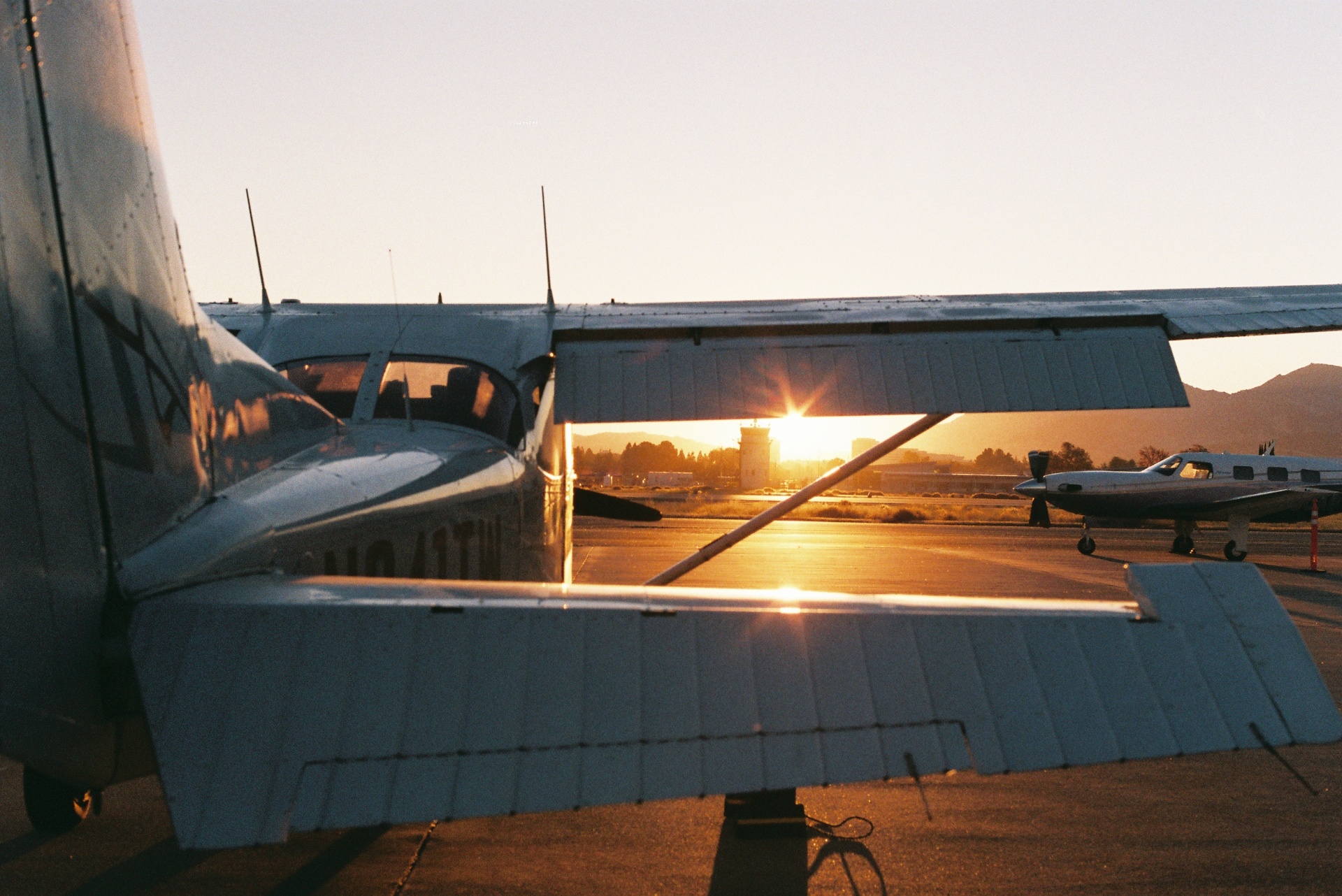 Cessna parked on the ramp at Buchanan Field (KCCR) during golden hour at sunset