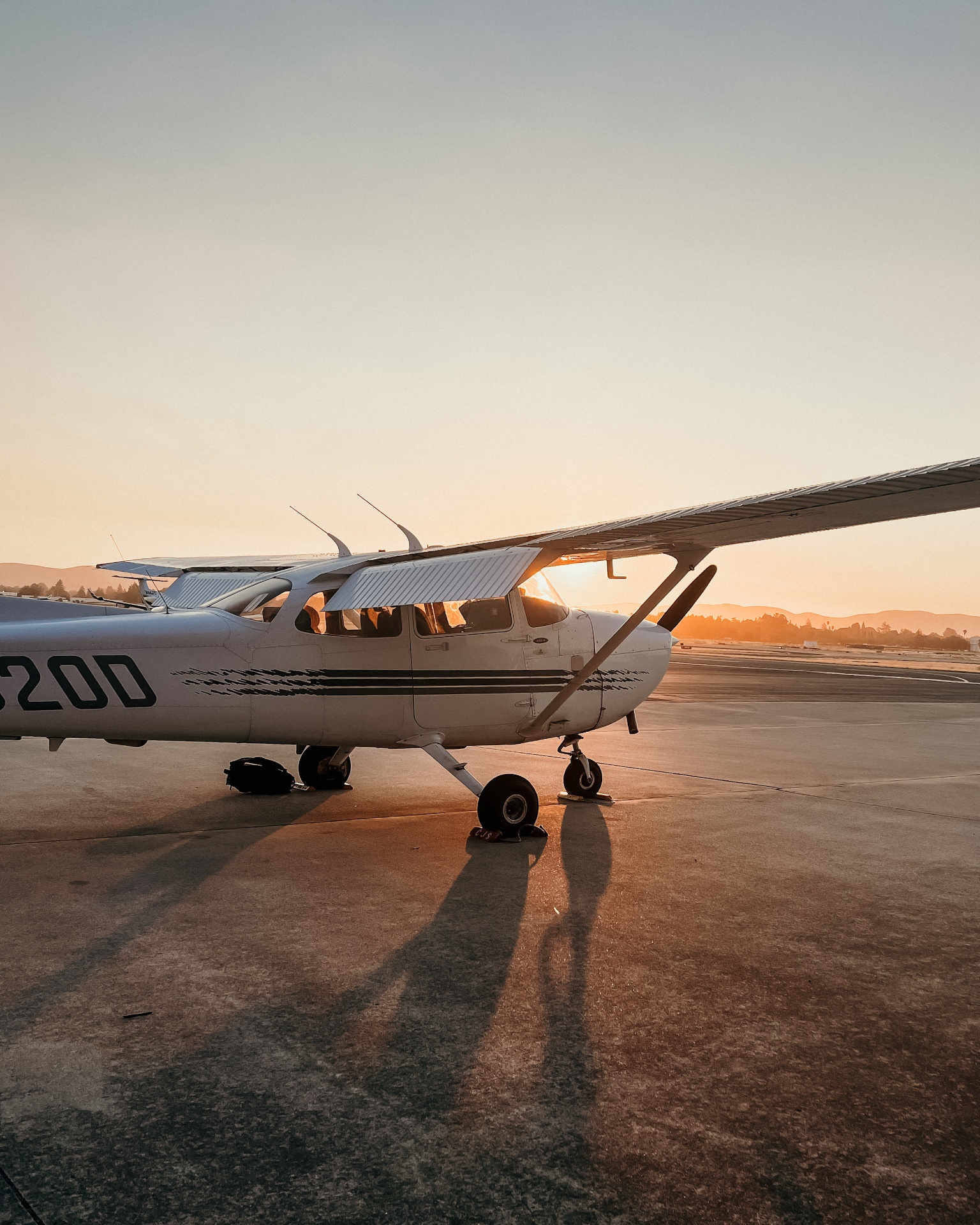 A Cessna 172 training aircraft on the ramp at golden hour at Buchanan Field Airport (KCCR) in Concord, California